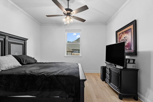 bedroom featuring ceiling fan, light hardwood / wood-style flooring, and ornamental molding