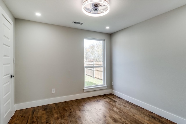 spare room featuring wood-type flooring and a wealth of natural light