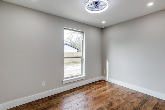 unfurnished room featuring plenty of natural light and wood-type flooring