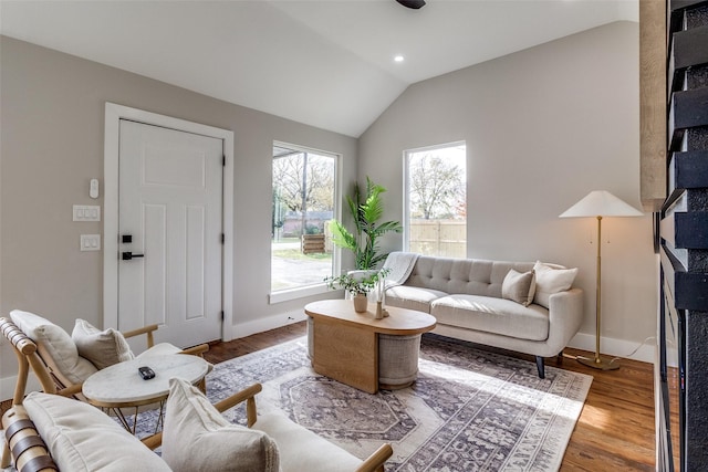 living room featuring hardwood / wood-style flooring and vaulted ceiling