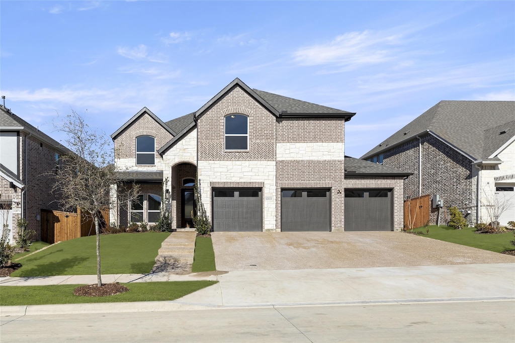 french country inspired facade featuring a front yard and a garage