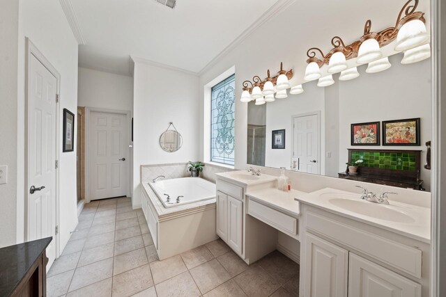 bathroom with tile patterned floors, vanity, ornamental molding, and a tub