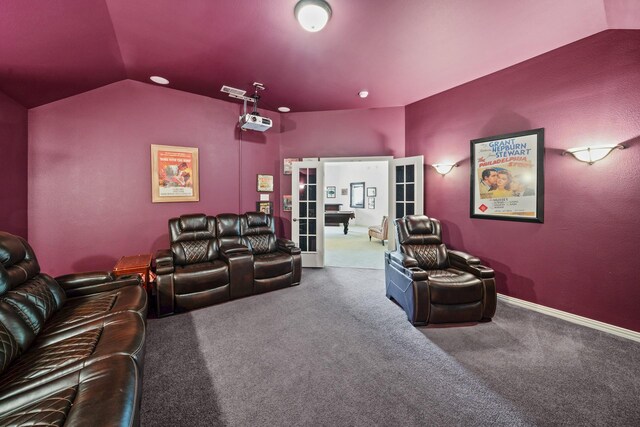 home theater with carpet flooring, french doors, and lofted ceiling