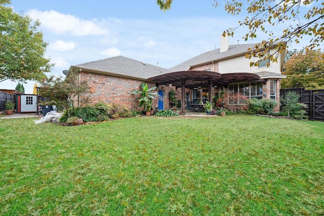 rear view of property featuring a pergola, a yard, and a storage shed