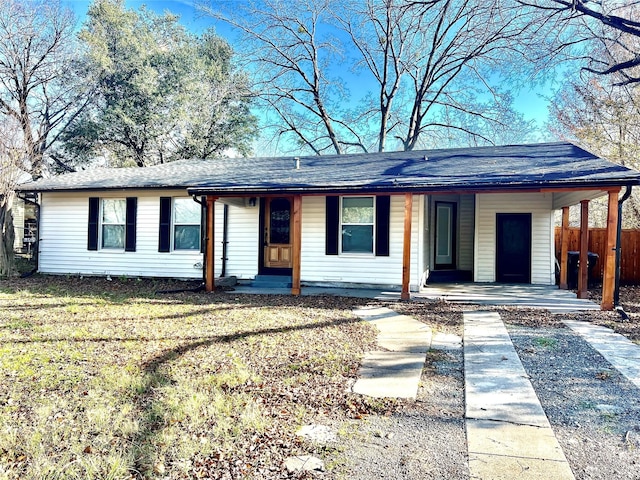 ranch-style home with a front yard and a carport