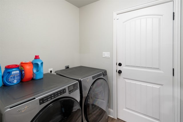 clothes washing area featuring separate washer and dryer