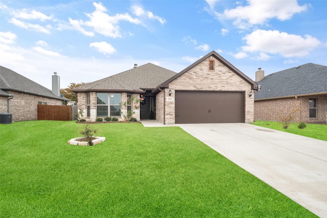 view of front facade featuring a front lawn, central AC unit, and a garage