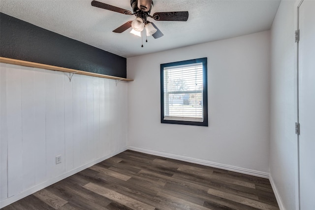 empty room featuring ceiling fan, dark hardwood / wood-style flooring, and a textured ceiling