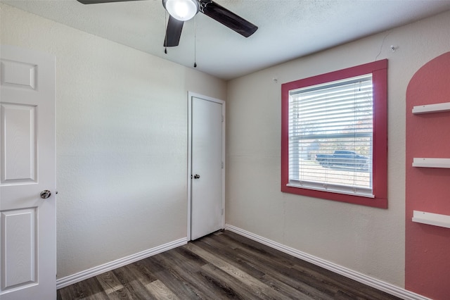 unfurnished bedroom featuring dark hardwood / wood-style flooring and ceiling fan