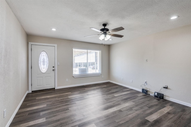 foyer with a textured ceiling, dark hardwood / wood-style floors, and ceiling fan