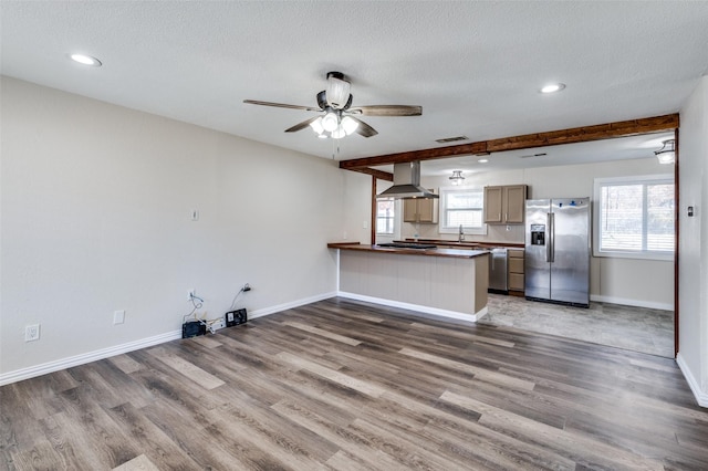 kitchen featuring kitchen peninsula, plenty of natural light, stainless steel appliances, and extractor fan