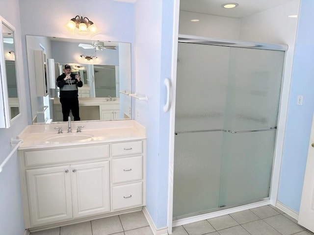 bathroom with tile patterned flooring, vanity, a shower with door, and ceiling fan