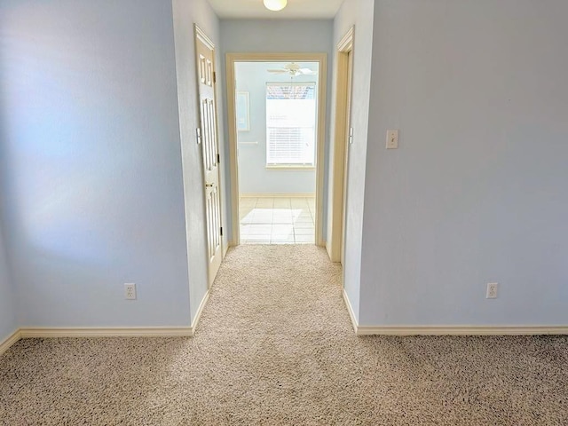 hall featuring light colored carpet