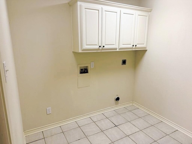 clothes washing area featuring electric dryer hookup, hookup for a washing machine, light tile patterned floors, and cabinets