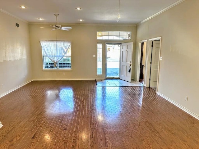 unfurnished room with ceiling fan, wood-type flooring, and ornamental molding