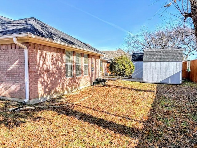 view of home's exterior with a yard and a storage shed