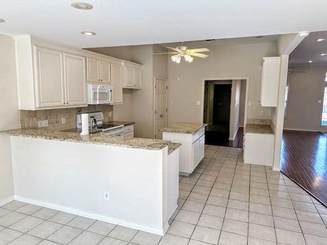 kitchen with kitchen peninsula, ceiling fan, electric stove, white cabinets, and light hardwood / wood-style floors