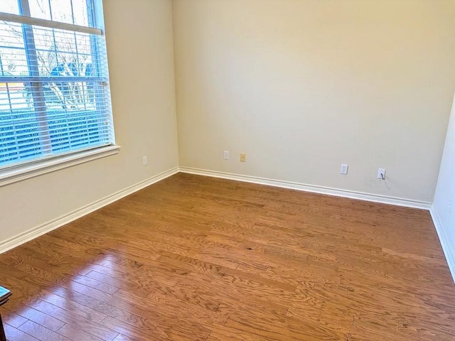 unfurnished room with hardwood / wood-style flooring