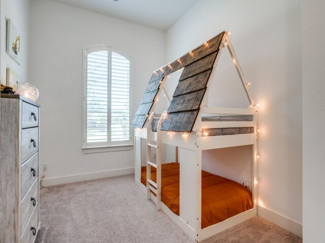 carpeted bedroom featuring ceiling fan and vaulted ceiling