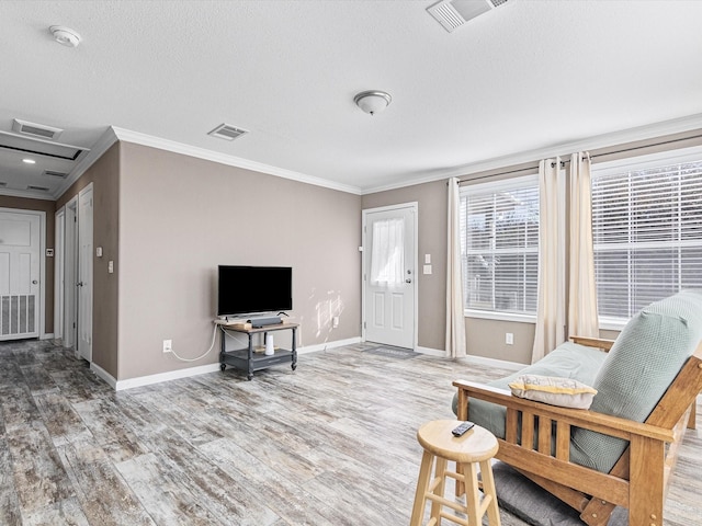 interior space featuring hardwood / wood-style flooring, a textured ceiling, and ornamental molding