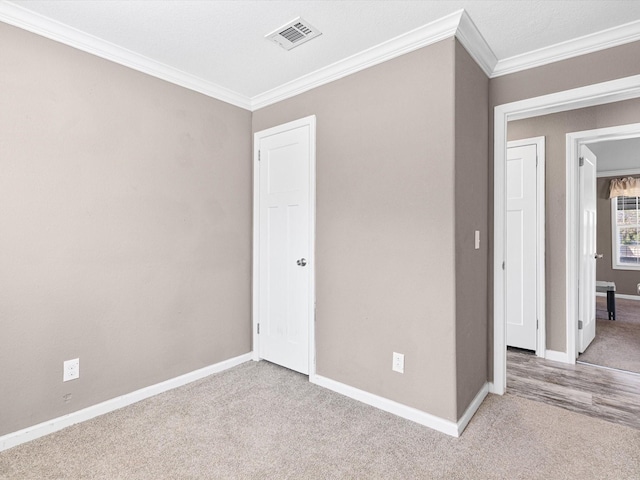 carpeted empty room with crown molding