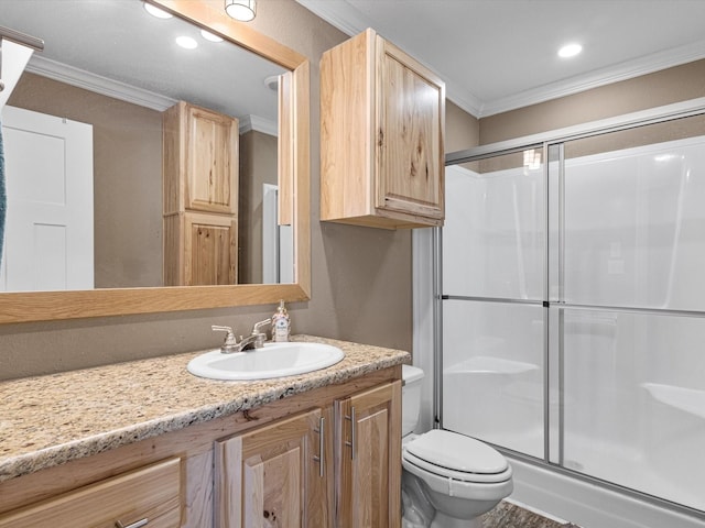 bathroom with vanity, an enclosed shower, and ornamental molding