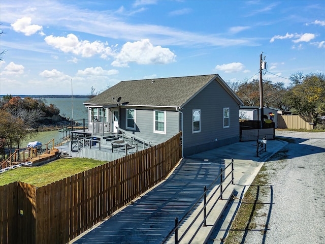 back of house featuring a deck with water view