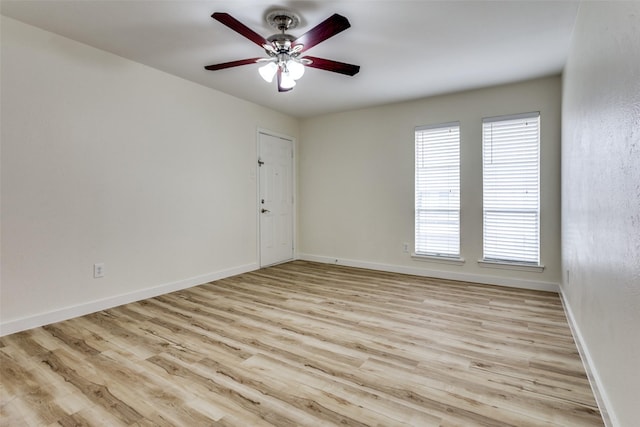 empty room with ceiling fan and light hardwood / wood-style floors