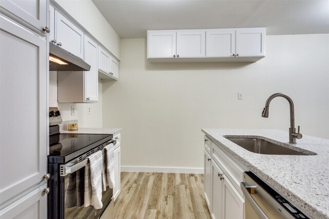 laundry area featuring washer hookup, cabinets, hookup for an electric dryer, hookup for a gas dryer, and light hardwood / wood-style floors