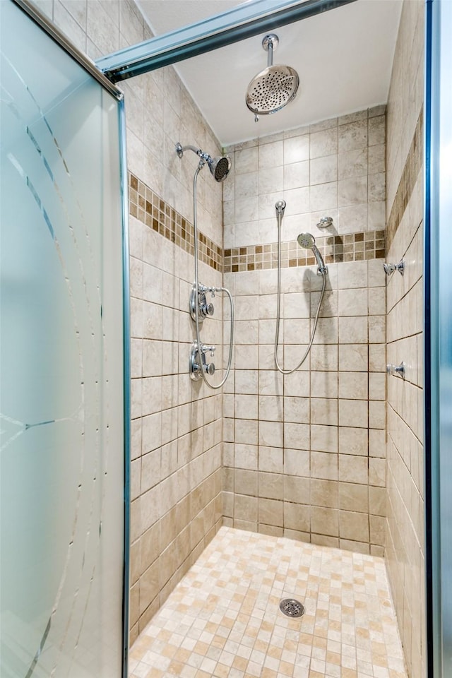 bathroom with a tile shower