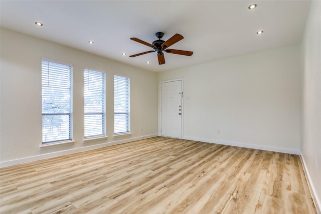 spare room featuring light hardwood / wood-style floors and ceiling fan