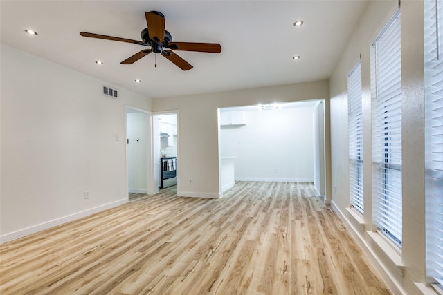 unfurnished living room with a healthy amount of sunlight, ceiling fan, and light hardwood / wood-style floors