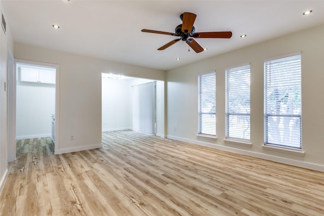 unfurnished room with ceiling fan and light wood-type flooring