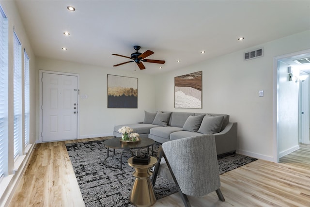 living room with ceiling fan and light hardwood / wood-style floors