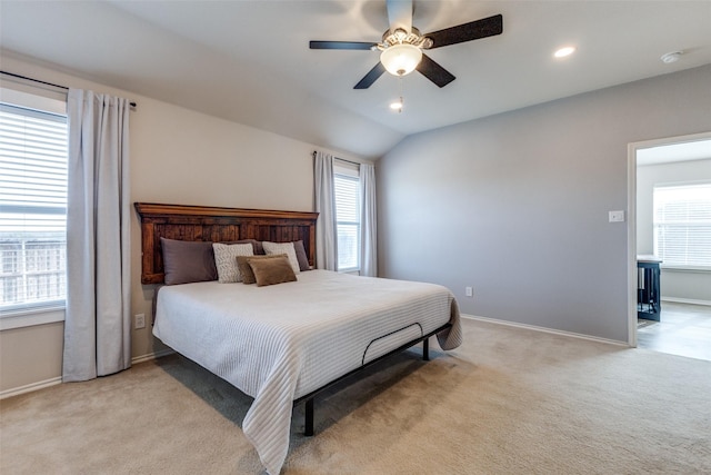 carpeted bedroom featuring multiple windows, vaulted ceiling, and ceiling fan