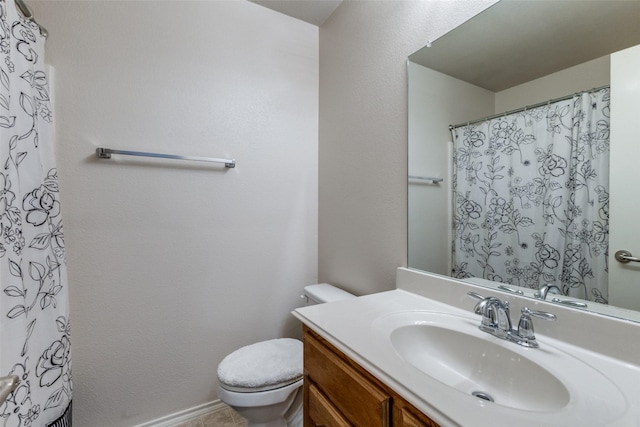 bathroom featuring toilet and vanity