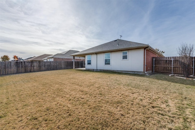 back of house featuring a lawn