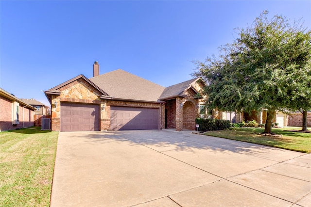 view of front of property featuring a garage and a front yard