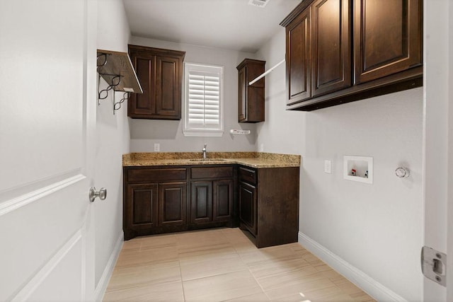 laundry room featuring hookup for a washing machine, sink, and cabinets