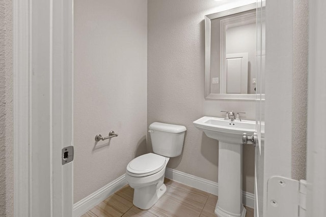 bathroom featuring toilet and sink