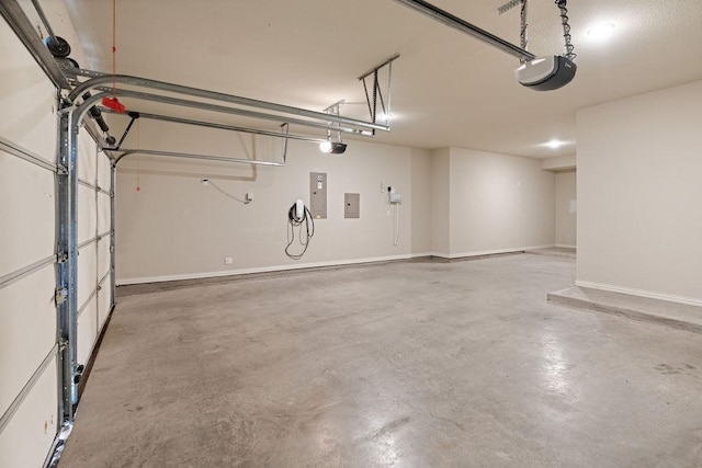 garage featuring electric panel and a garage door opener