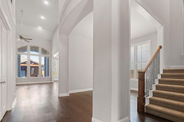 interior space with a high ceiling and dark wood-type flooring