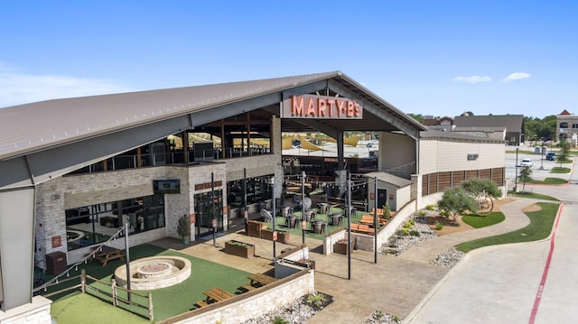 view of building exterior featuring an outdoor fire pit