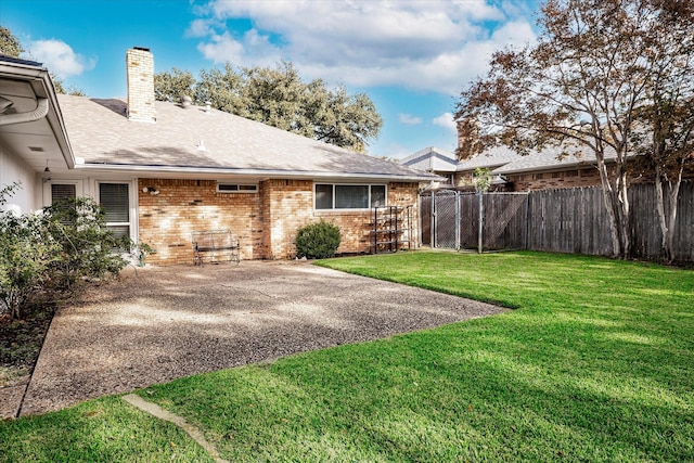 rear view of property featuring a yard and a patio area