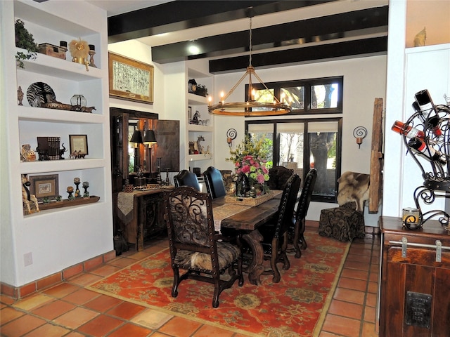 dining area featuring beamed ceiling, tile patterned floors, built in features, and a chandelier