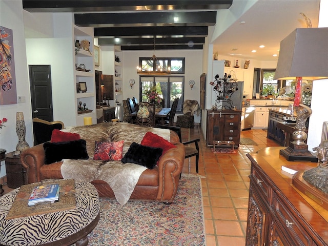 living room with a healthy amount of sunlight, light tile patterned floors, and beamed ceiling