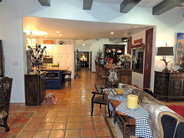 tiled dining area featuring ceiling fan with notable chandelier and beam ceiling