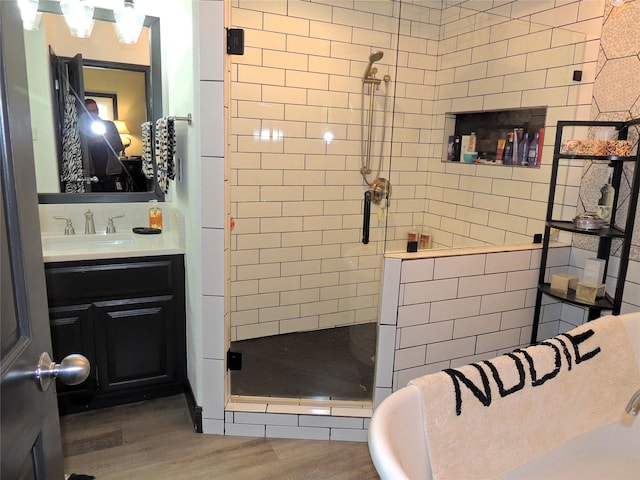 bathroom featuring vanity, hardwood / wood-style floors, and walk in shower