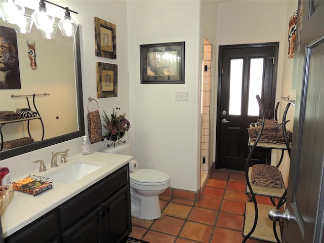 bathroom featuring vanity, tile patterned floors, and toilet