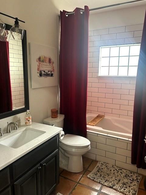 full bath with toilet, tile patterned flooring, vanity, and tiled shower / bath